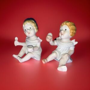 “Adorable mischief-makers: spoon & bread in hand, ready to steal your heart!”